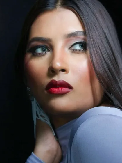A classic beauty shot, highlighting the contour and the striking red lip.