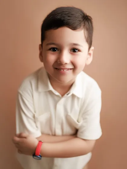 It's not just about babies. I love capturing the bright, shiny-eyed joy of older kids too. This studio portrait shows the pure, happy personality of a young boy, a memory his family will treasure as he grows.