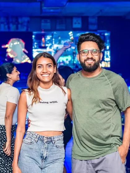 A couple enjoying the vibrant, blue-lit atmosphere.