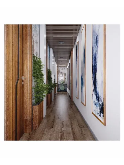 The private lobby connecting the directors' cabins, designed as a transitional space. We used wooden accents, recessed planter boxes, and abstract art to make the narrow passage feel warm and spacious.