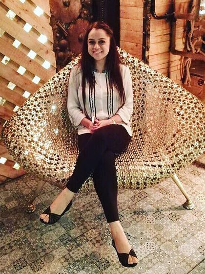 This is a great example of a relaxed yet put-together look. A simple white tunic with black vertical stripes paired with black leggings is comfortable for a long day but still looks chic and intentional.