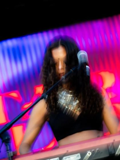 Tara Lily on the keyboard, lost in the music. I curate my lineups to feature a diverse range of instrumentalists and vocalists, creating a rich and layered musical experience.