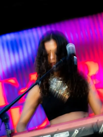 Tara Lily on the keyboard, lost in the music. I curate my lineups to feature a diverse range of instrumentalists and vocalists, creating a rich and layered musical experience.