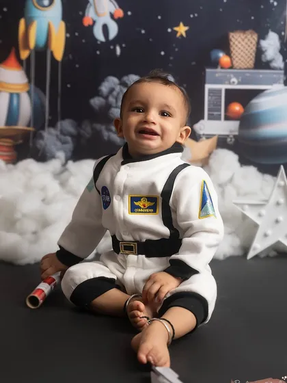 A happy astronaut, ready for takeoff! This little one loved his space-themed sitter session.