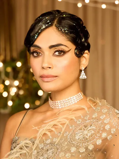 I love diving into vintage looks, and this Gatsby-inspired style was for a special cocktail party theme. I created classic 1920s finger waves with a modern twist of hair glitter, paired with a dramatic winged eyeliner and glowing skin to capture the opulence of the era.