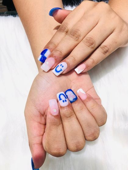 A close-up of the cartoon and "under art" nails, where the design is on the underside of the clear tip.