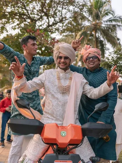 The groom making a grand entrance on a scooter at his beachside Goa wedding. So much fun and personality.