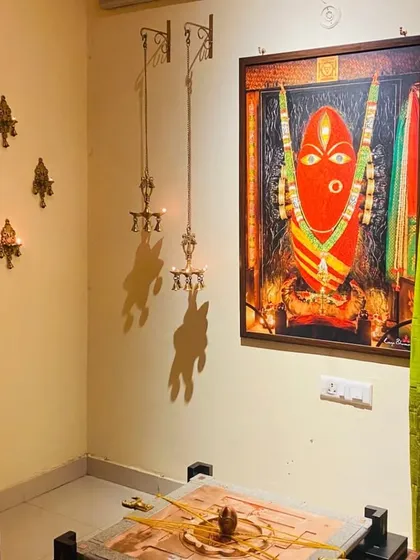 The Devi Avighna Yantra, beautifully set up with 11 brass lamps and draped with a sacred cloth. This consecrated form fills the space with a transformative energy and a profound sense of stillness.