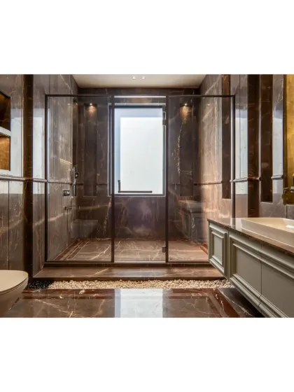 This bathroom is a sanctuary of calm, wrapped in dark grey marble. The glass-enclosed shower area features a pebble floor, adding a natural, spa-like texture to the space.