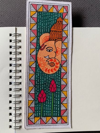 A beautiful Madhubani bookmark featuring Ganesha, created by a student as part of her assignment. It is a perfect example of applying traditional art to functional items.