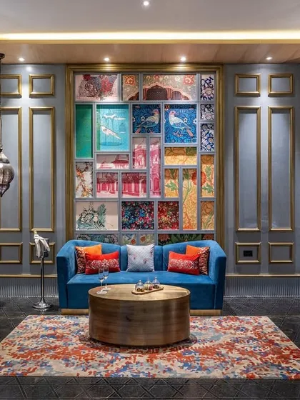 This seating nook at Taj Devi Ratn showcases a stunning fabric collage wall I designed as a focal point. The vibrant patchwork of textiles, framed by classic moulding, creates a gallery of color and texture that celebrates Indian craftsmanship.