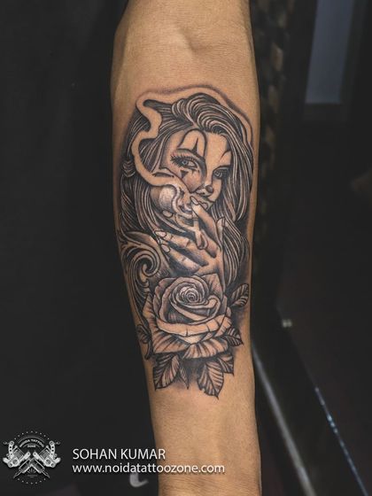 We covered an old tattoo with this custom-designed Chicano-style girl with a rose. The detailed line work and heavy black and grey shading are perfect for cover-ups, allowing us to create a complex and beautiful new image.