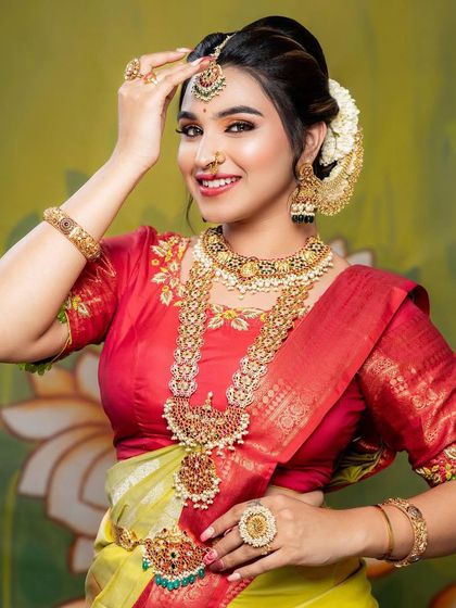 A playful and confident pose. This shot shows the full splendour of the layered necklaces and the matching hair accessories.