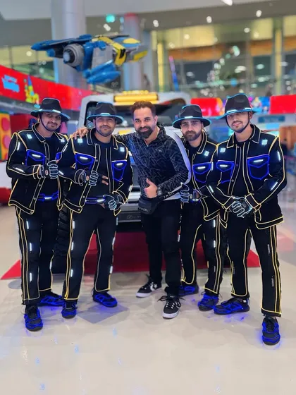 A picture with a fan or event organizer during our time in Doha. We love meeting people who enjoy our work wherever we go.