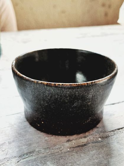 After her beginner's course, this student rejoined for the advanced level. She created beautiful wheel-thrown mugs and bowls, and also explored sculptural hand-building, creating this unique candlestick holder.