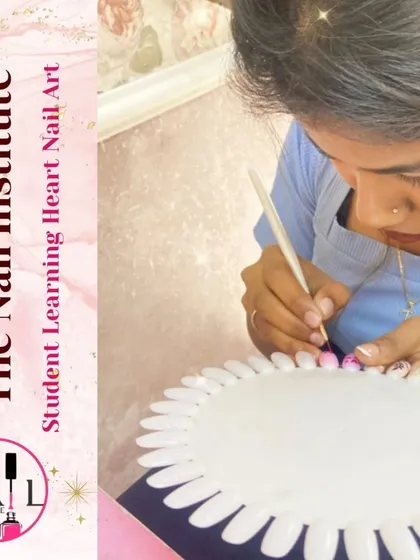 A student practices painting delicate heart designs, a popular request for many occasions.