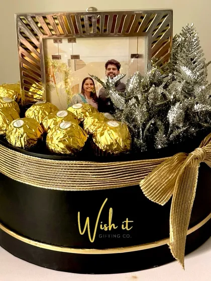 A wedding hamper with a touch of silver and gold. This custom creation features a personalized photo frame and Ferrero Rocher chocolates, making it a perfect anniversary or wedding gift.