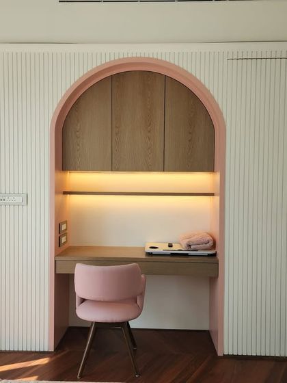 A sneak peek of a tranquil study nook we're creating at our Indiabulls Blu project. The soft pink arch and fluted wall panels create a calm and focused workspace with a touch of elegance.