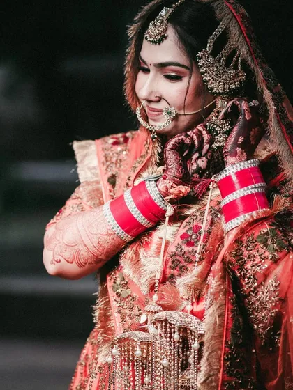 A close-up of the Sikh bride, focusing on her traditional jewelry and 'chooda'.