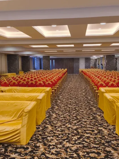 Seating arrangement at Palm Beach Banquet in Vashi. The hall is set up with covered sofas and chairs, ready to welcome guests for a comfortable experience.