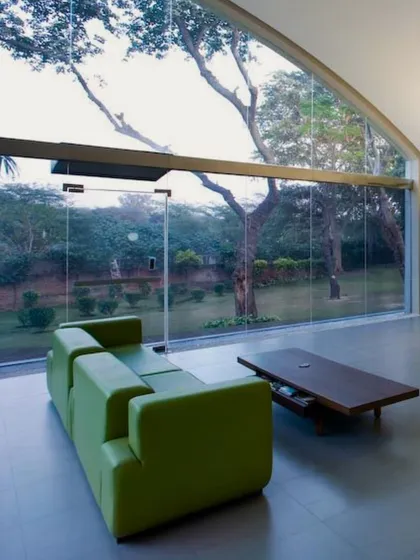 An adaptive reuse project in Okhla, where we transformed an old industrial shed into a modern workspace. By retaining the original form and opening it up to the surrounding greenery with large glass facades, we created a workplace that blurs the line between indoors and outdoors.