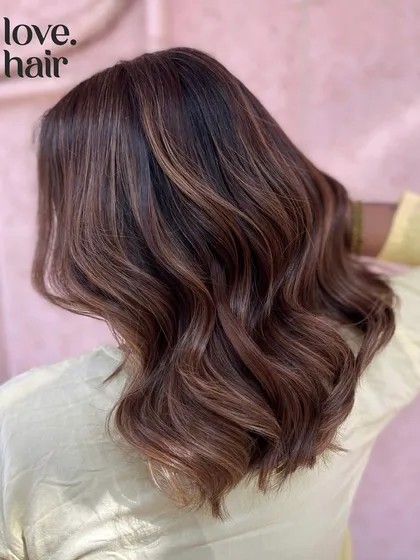 A side view of the Vietnamese brew balayage, showing its beautiful dimension and shine.