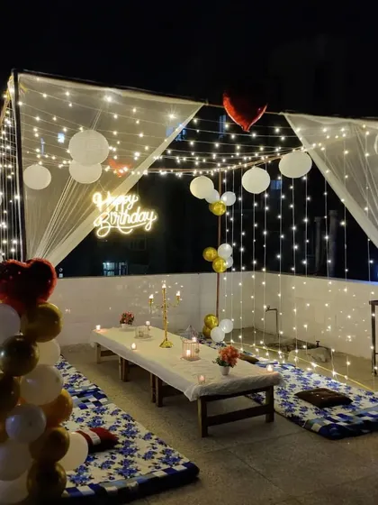 This angle highlights the enchanting canopy of fairy lights and paper lanterns above the cabana dinner setup. We pay attention to every detail to ensure a cozy and romantic atmosphere for your special occasion.
