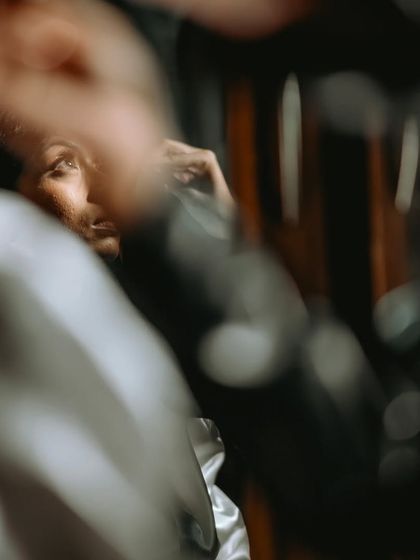 An artistic, abstract shot of the bride's prep, using reflections and foreground elements to create a unique composition.