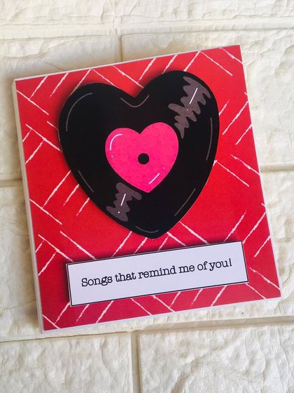 The cover of a birthday Spotify slider card, designed to look like a heart-shaped vinyl record. It includes 5 photos, 5 songs, and a message.