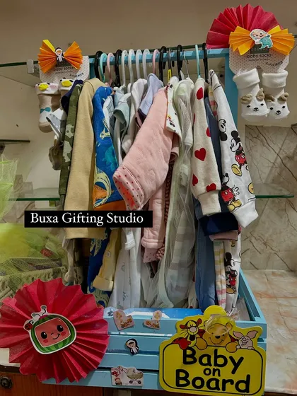 A view of my baby hamper trays, including the baby wardrobe and a Cocomelon themed basket, showing the variety I offer for newborn gifts.