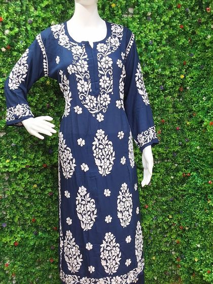 A classic navy blue Lucknow Chikankari kurti. The detailed white embroidery provides a crisp contrast, making it an elegant choice for office wear or casual outings.