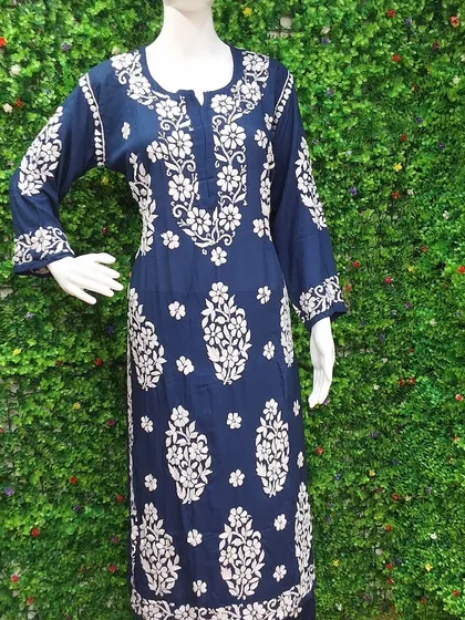 A classic navy blue Chikankari kurti with intricate white floral embroidery. This is a versatile piece that can be styled for both casual and semi-formal occasions.