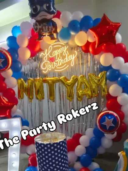 A closer look at the Captain America balloon arch, showing the character foil balloon and the star-shaped accents.