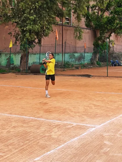 A young player hitting a clean backhand on the run. Our drills are designed to improve shot-making in dynamic, match-like situations.