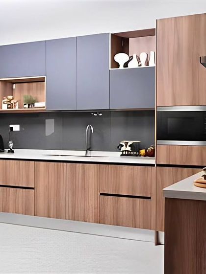 This kitchen design combines wood-finish cabinets with muted grey upper units for a contemporary look. We included open shelving and a dedicated space for a built-in microwave to maximize both style and convenience.