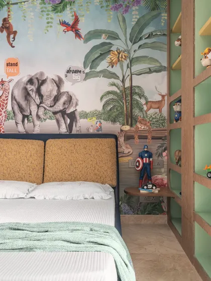 Another detail of the jungle-themed room, showing how the wallpaper and custom shelving come together to create an immersive and playful environment.