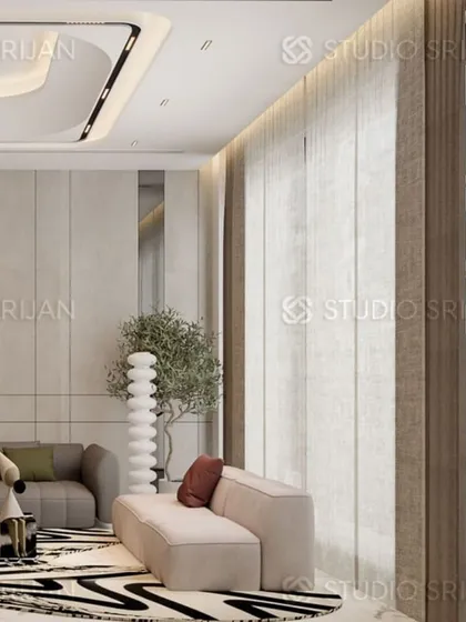 A detail shot from a drawing area in Model Town, New Delhi, showcasing a modern sectional sofa and a unique floor lamp. The design focuses on clean lines and a calm, neutral color palette.