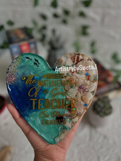 Holding the finished teacher gift. The heart shape, ocean waves, and meaningful quote make it a truly special piece.