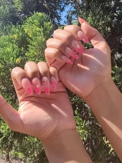 A client's sunny photo of her pink jelly nails with delicate rhinestone accents. The transparency of the jelly polish makes the gems stand out.