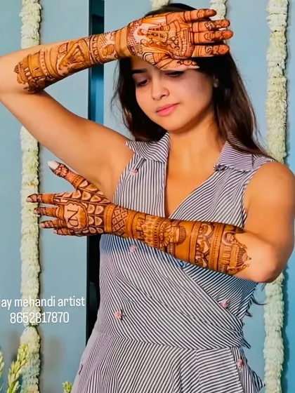 A stylish pose showing the 'N' initial on the back of the hand, perfect for an engagement or sangeet ceremony.