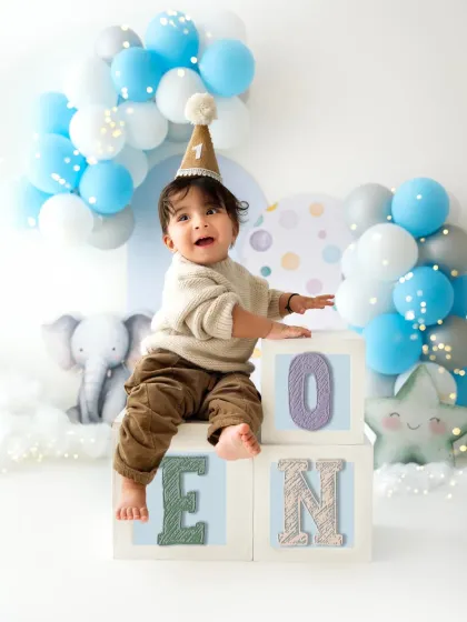 Another adorable shot from a first birthday session, with colorful "ONE" blocks. These milestone photoshoots are a wonderful way to mark the occasion.