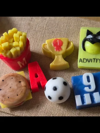 A custom hamper for a teenage boy's 9th birthday. It includes soaps shaped like a burger, fries, a trophy, and a soccer ball, plus his initial and a personalized superhero soap.