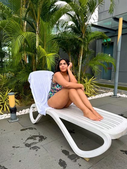 A more contemplative pose, enjoying a quiet moment by the pool.