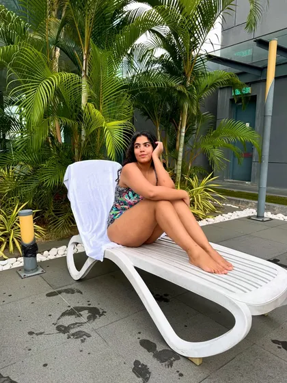 A more contemplative pose, enjoying a quiet moment by the pool.