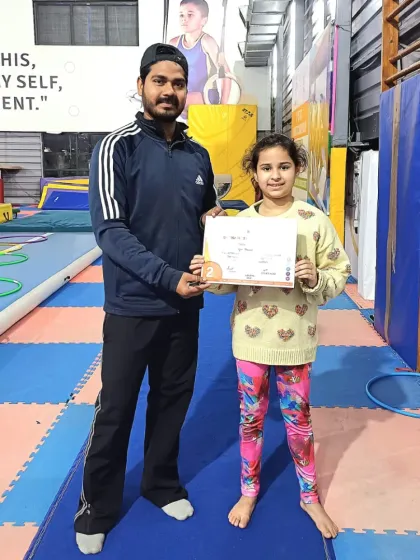 This student is happy to receive her certificate from her coach.