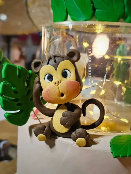A detailed shot of the cute fondant monkey figurine from the jungle cake.