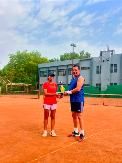 Eshanya Khattar receives her trophy on the court after winning the AITA CS National U-16 singles tournament. This was her second consecutive title win.