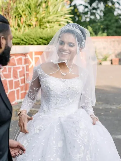 The bride's joyful expression as she approaches her groom for their first look. Her smile says it all, capturing the excitement of this private reveal.