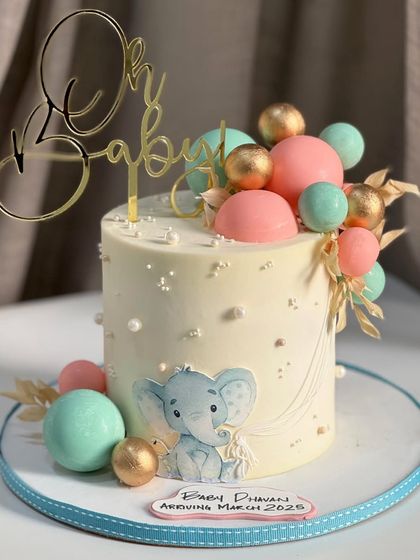 Oh Baby! This cake welcomes a new beginning with sweetness, featuring soft pastels, tiny pearls, and the cutest little elephant. It's a memory you can taste.