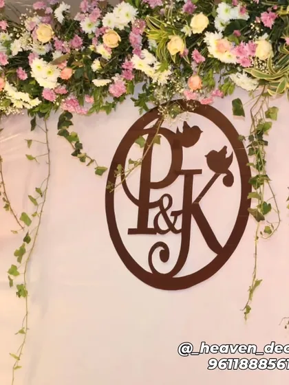 We believe in personal touches, like this custom wooden monogram featuring the couple's initials. Paired with fresh flowers and trailing ivy, it adds a unique and meaningful detail to any engagement or wedding backdrop.
